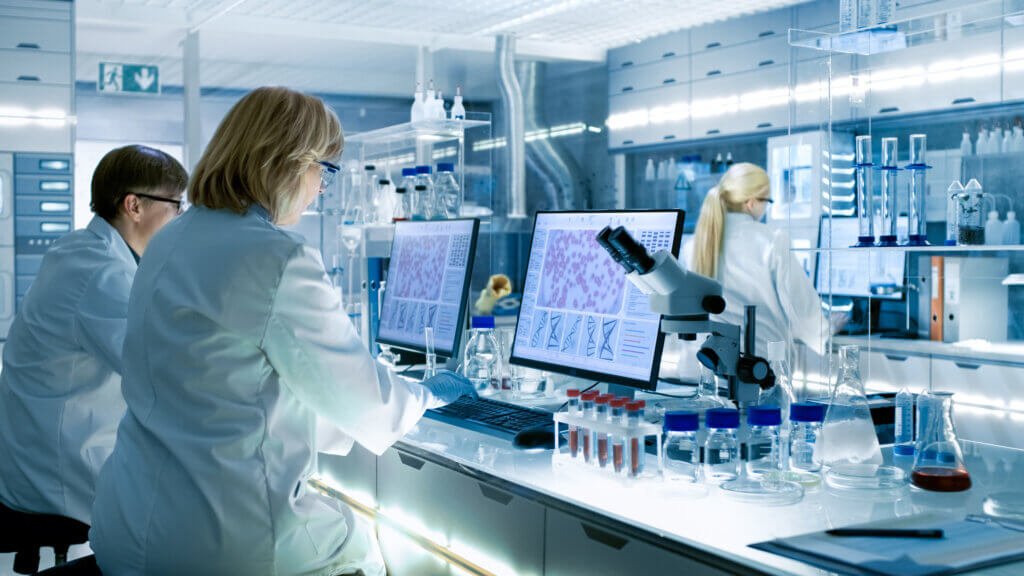 Female and Male Scientists Working in their Laboratory.