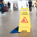 Sign showing warning of caution wet floor in airport
