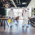 The image of two people disinfecting a hotel using EN 14347 tested disinfectant product