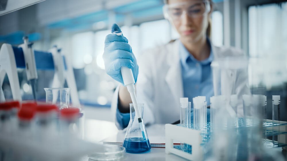 Image shows a researcher testing disinfectants as per EN 1040 standards