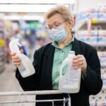 An elderly women checking product labels before purchasing
