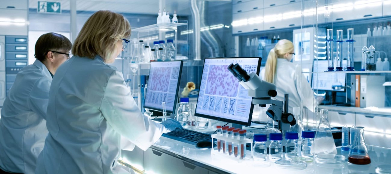 Female and Male Scientists Working in their Laboratory.