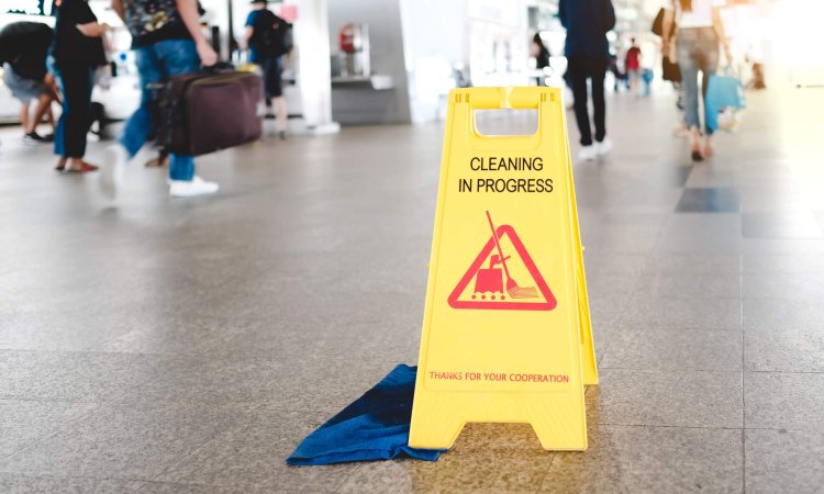 Sign showing warning of caution wet floor in airport