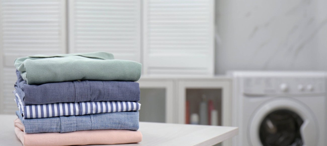 Fresh,Laundry,On,White,Wooden,Table,In,Bathroom.,Space,For
