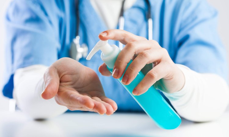 Doctor,Using,Hand,Sanitizer,Gel,,Medical,Specialist,Disinfecting,Hands,With
