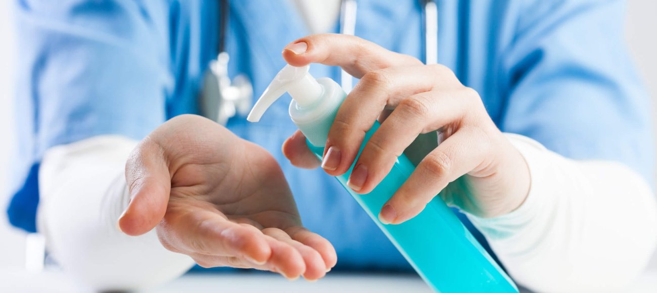 Doctor,Using,Hand,Sanitizer,Gel,,Medical,Specialist,Disinfecting,Hands,With