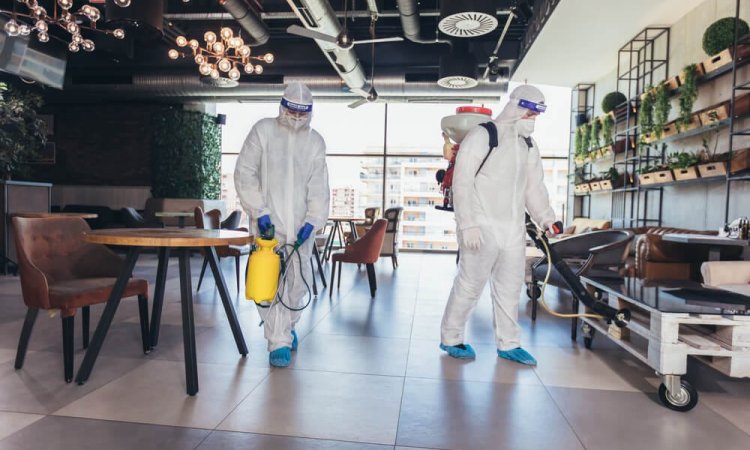 The image of two people disinfecting a hotel using EN 14347 tested disinfectant product