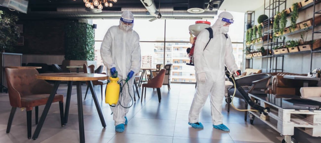 The image of two people disinfecting a hotel using EN 14347 tested disinfectant product