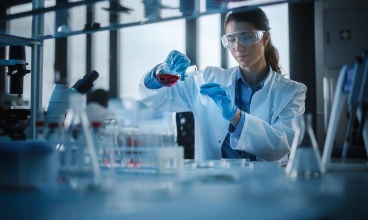 Beautiful,Female,Scientist,Wearing,Protective,Goggles,Mixing,Chemicals,In,A