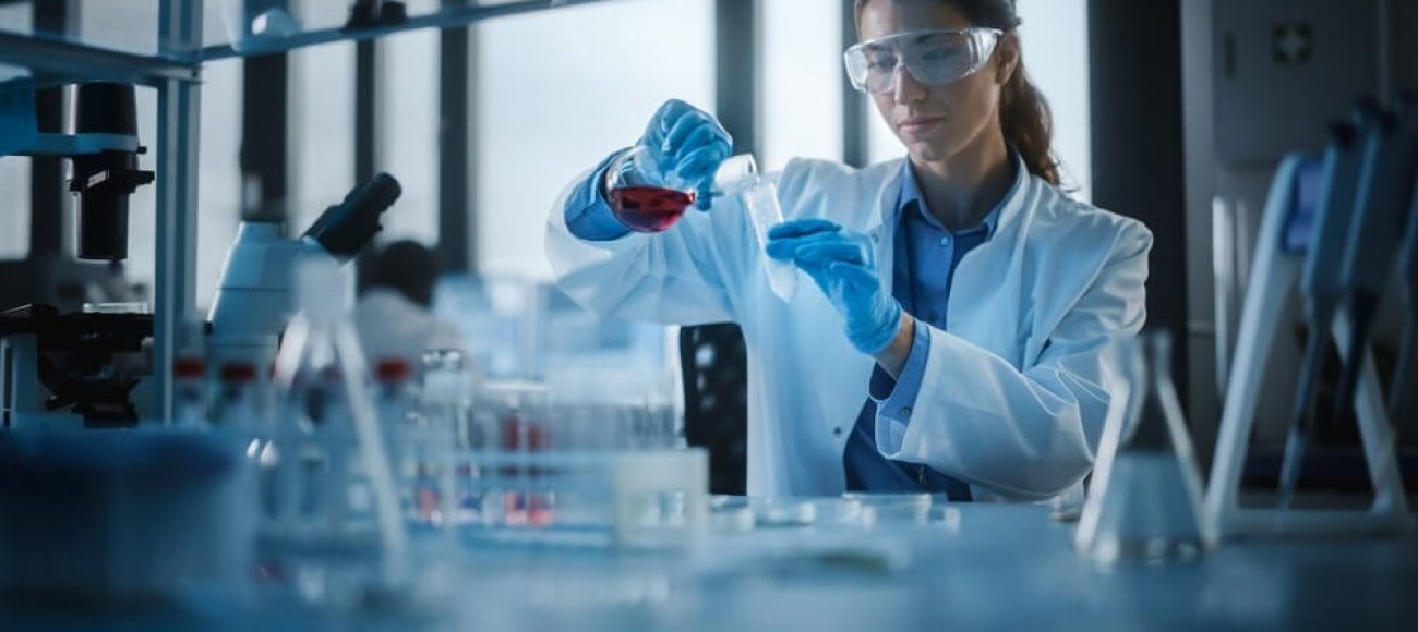 Beautiful,Female,Scientist,Wearing,Protective,Goggles,Mixing,Chemicals,In,A