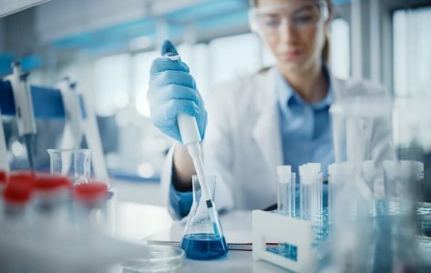 Image shows a researcher testing disinfectants as per EN 1040 standards