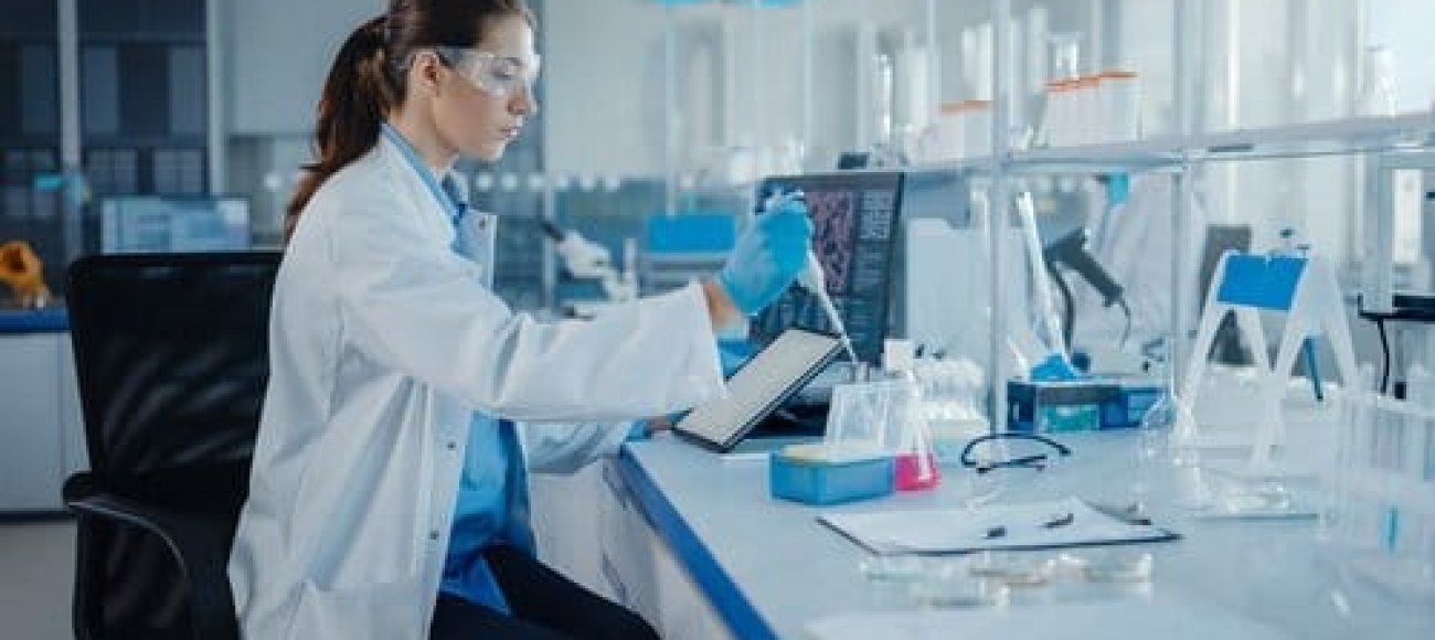 Image shows a researcher performing EN 1040 test on disinfectants used in healthcare facilities.