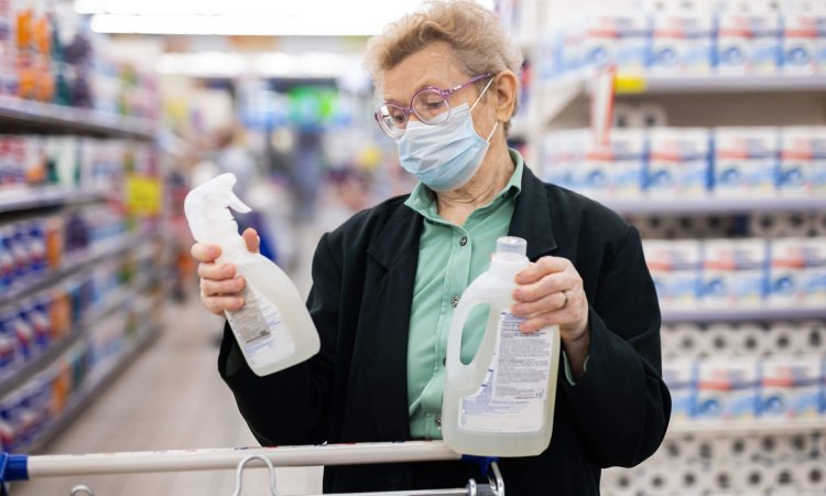 An elderly women checking product labels before purchasing