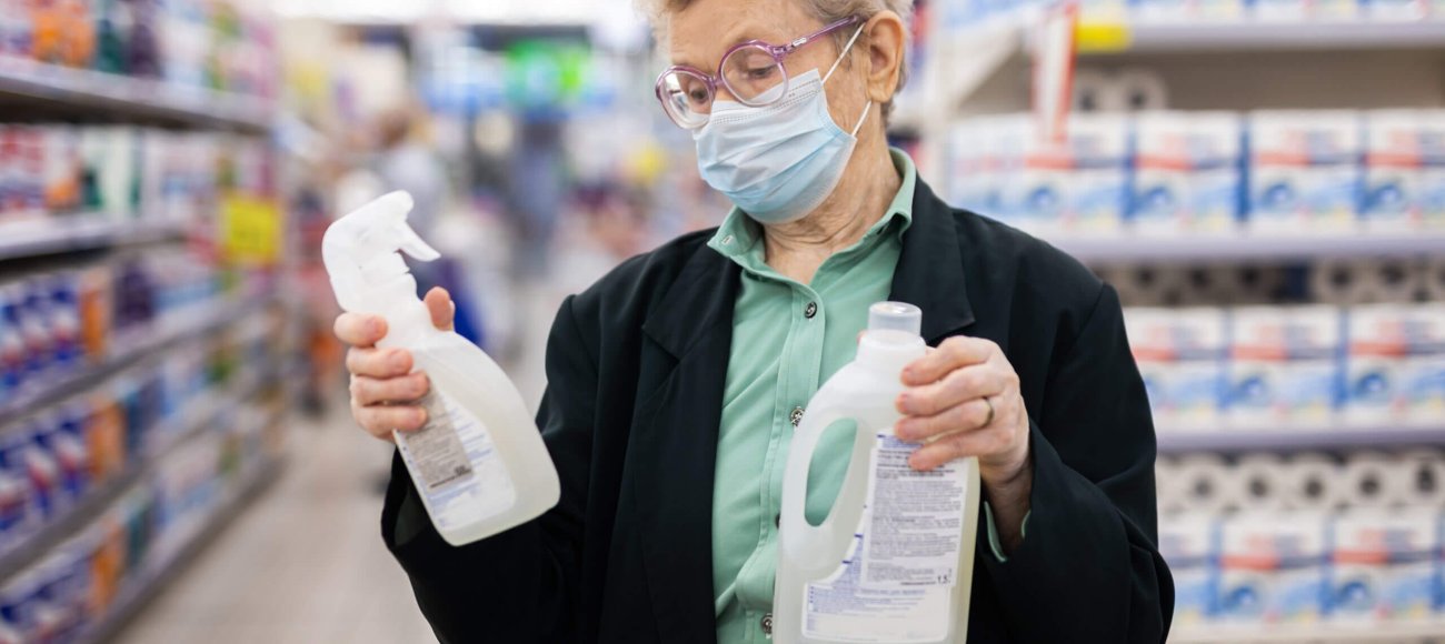 An elderly women checking product labels before purchasing
