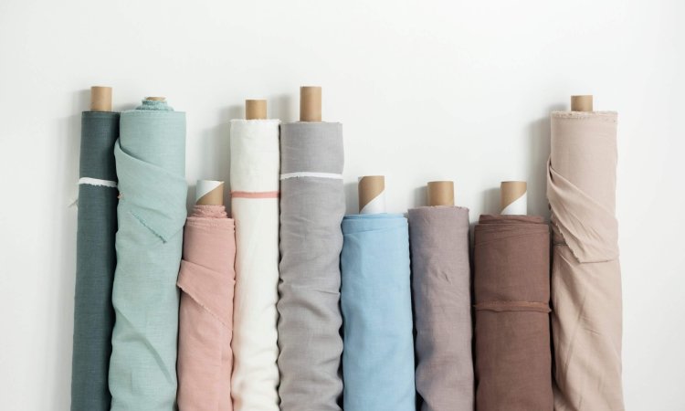 Different,Colors,Fabric,Linen,Rolls,On,The,White,Walls,,Selective