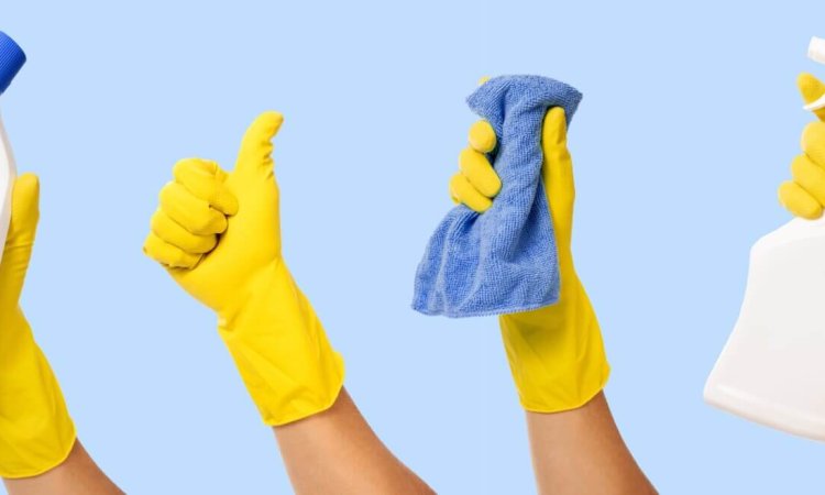 hands with gloves holding cleaning products